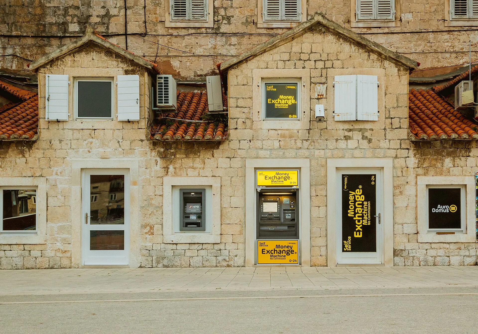 ATM machine in old building in Trogir Croatia. ATM Route Location: Assess Demand and Test Sites